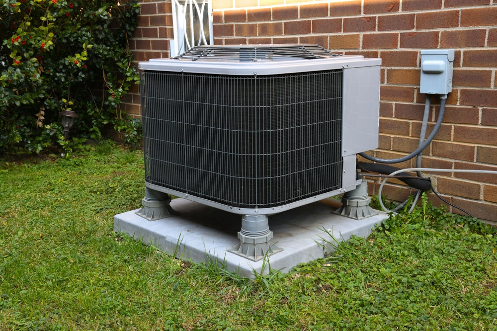 Outdoor air conditioning unit mounted on a raised base